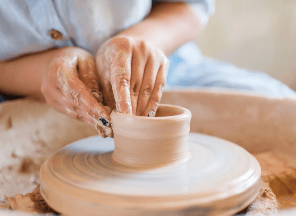 Clay making process showing hands crafting pottery